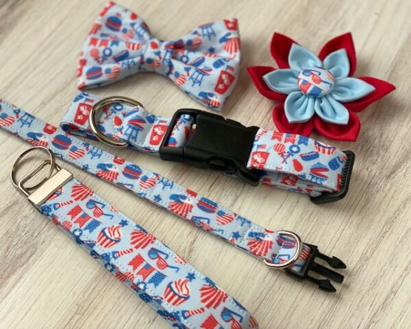 A dog collar, bow tie and flower on top of a table.